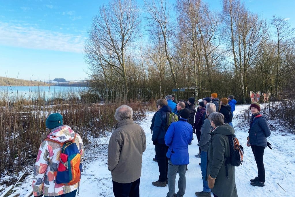 Gallery2_AndyHay A group of people looking out on a lake at an RSPB reserve in the snow